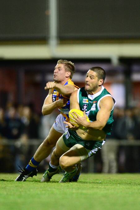 CONTEST: Brendan Fevola attempts to mark in front of Golden Square's Dale Young. Picture: JIM ALDERSEY