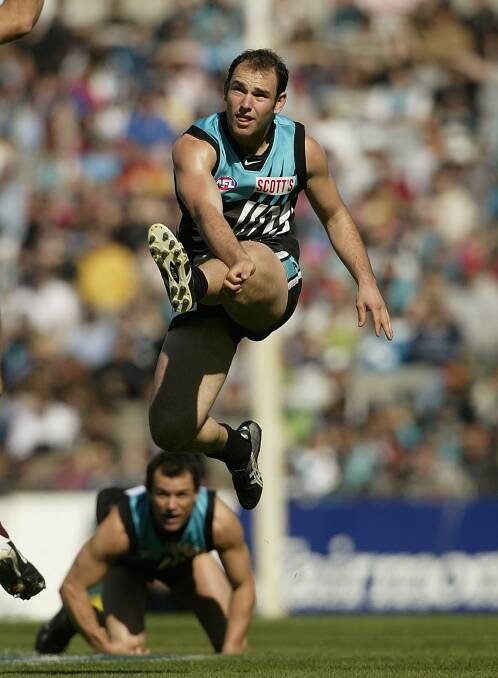 Kicking the Power into attack against Brisbane in round 22, 2002. Picture: GETTY IMAGES