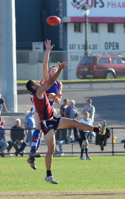 GREAT FORM: Gisborne's Tom Waters and Sandhurst's Tim Martin do battle in a centre bounce last Saturday. Picture: PETER WEAVING