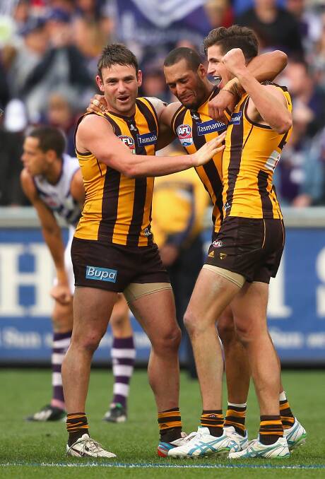 Guerra, Gibson and Stratton embrace after the final siren. Picture: GETTY IMAGES