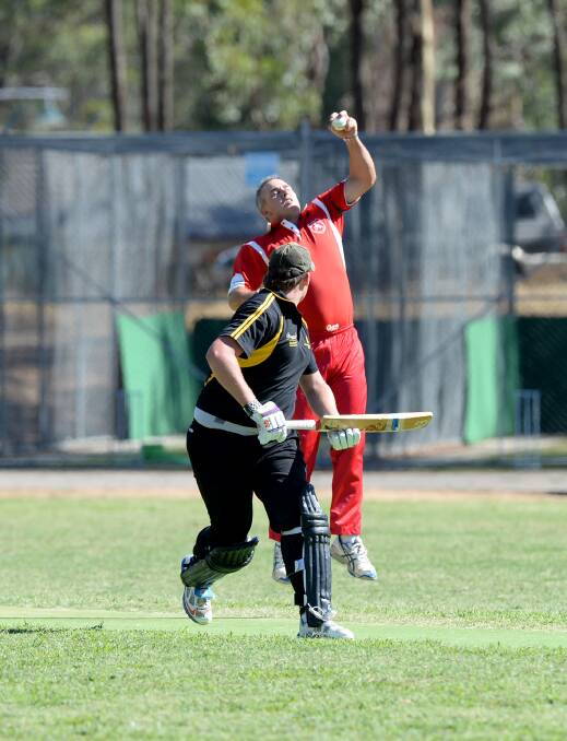 Mandurang's Warrick Behrens stops a straight drive in the super over.