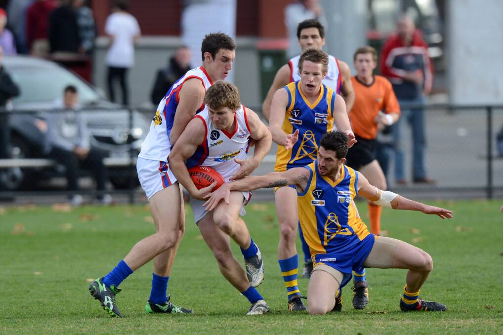 BATTLE FOR THE BALL: Action from the Bendigo versus Gippsland clash at the QEO in 2012. Picture: MATT KIMPTON