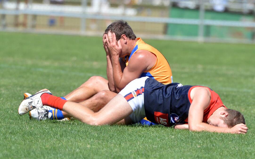 UNLUCKY BREAK: Golden Square's Corey Jones covers his face after colliding with a Shepparton United opponent on Saturday. Picture: GLENN DANIELS
