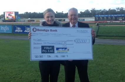 WINNERS ARE GRINNERS: Suzie Pedrotti receives her cheque from Filkel's Geoff McLeod.