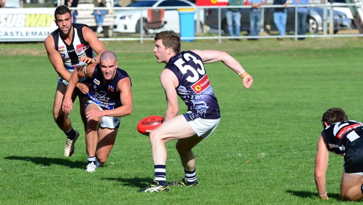 QUICK HANDS: Strathfieldsaye's Tom Dowd fires out a handball against Castlemaine. Picture: PETER WEAVING