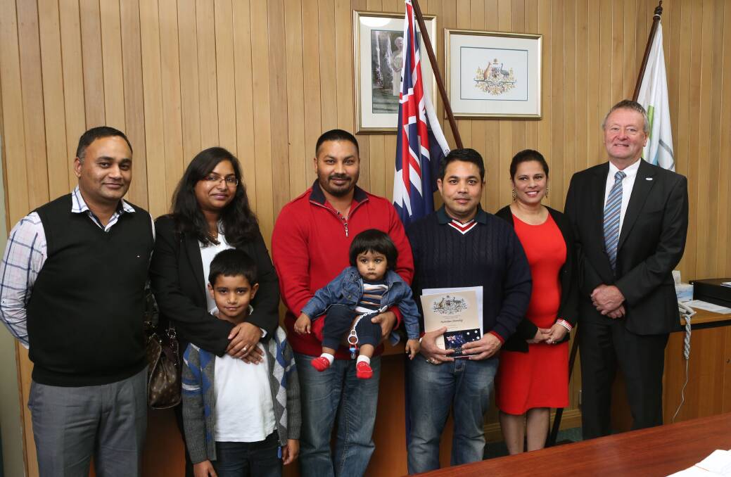 SUPPORT: Divya and Raman Sharma with Mayor Cr Gavan Holt and friends and family. Pictures: PETER WEAVING