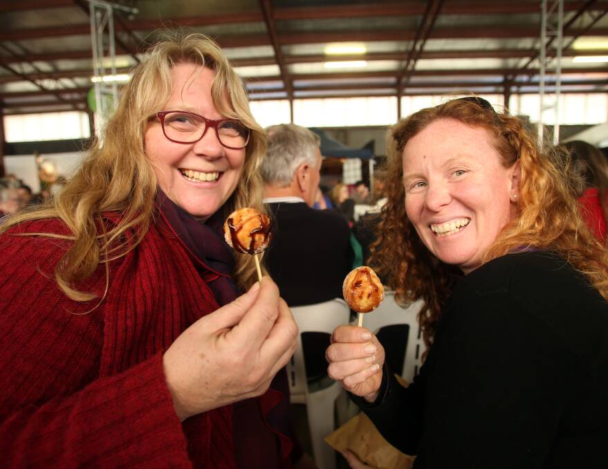 Janet Ray and Kim Cornford enjoying the fashion parade and treats on offer. Picture: GLENN DANIELS