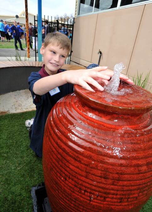 WATER: Ben enjoys the water feature in the new garden. 
Picture: JODIE DONNELLAN 
