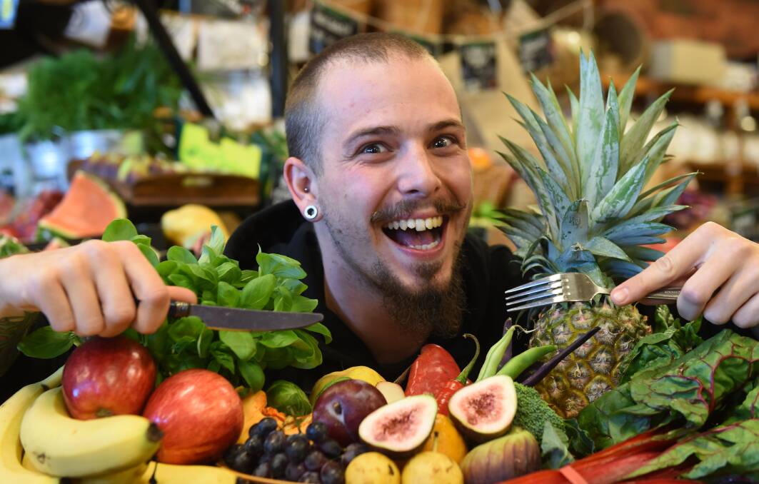 TUCK IN: Bendigo Wholefoods team member Kyle Murphy with a colourful plate of fruit and vegetables. The majority of Bendigo residents are not eating enough fruit or veggies. Picture: JODIE WIEGARD