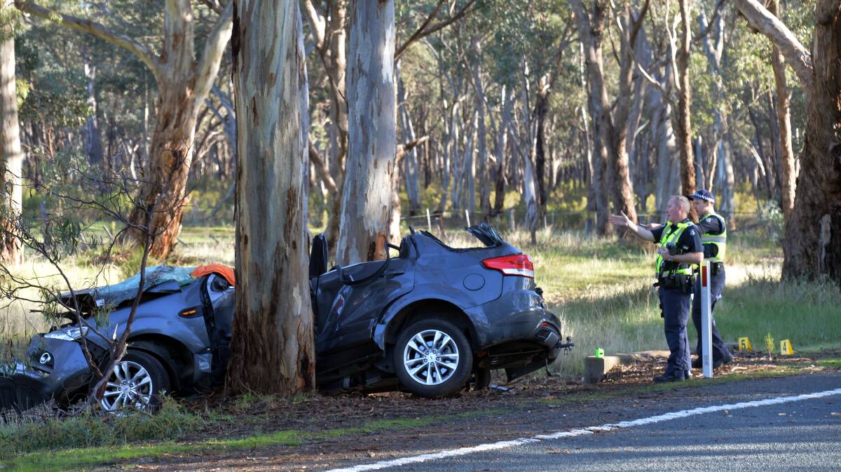 ACCIDENT: Police examine the car involved in yesterday's crash in Toolleen. Picture: BRENDAN McCARTHY