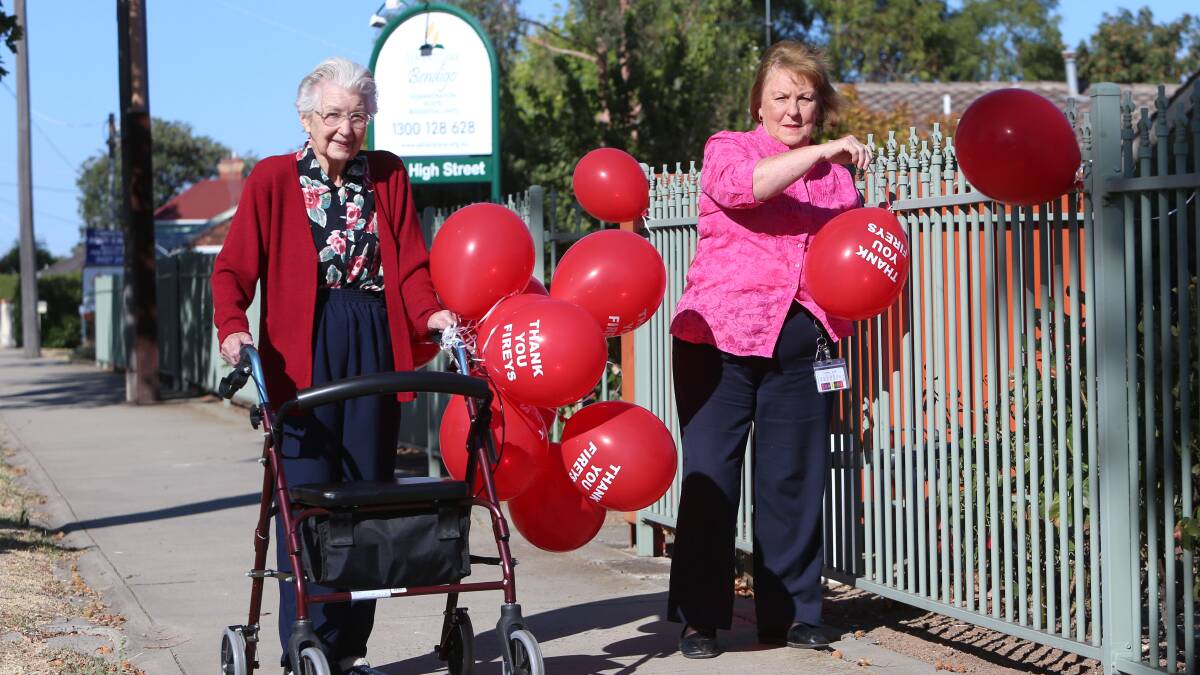 Jean Mannix and Hazel Abbott at Advent Care put up balloons.
Picture: Peter Weaving