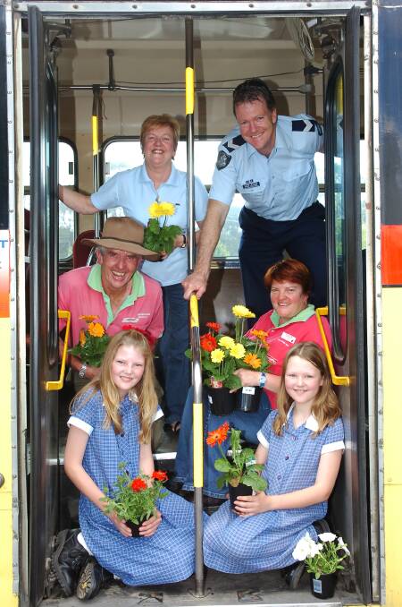 Rear l-r Jan Pithie (Rotary Club of Bendigo-Strathdale), Sen. Const Terry Davies, Ctr l-r Keith and Fiona McDonald of McDonalds Nursery, Front l-r Kassandra and Brydie Davies on the youth bus to promote the auction for Rotary.
Picture: Brendan McCarthy 311005
