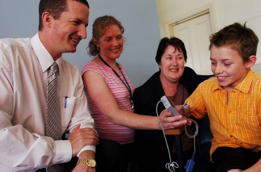 l-r Marc Sertori of City Family Hotel, Home Care Nurses Jacquie Robertson and Annette Pearce road test the new oximeter, donated by City Family Hotel, on Harley Hicks-Clark 12.
Pic Brendan McCarthy 041105