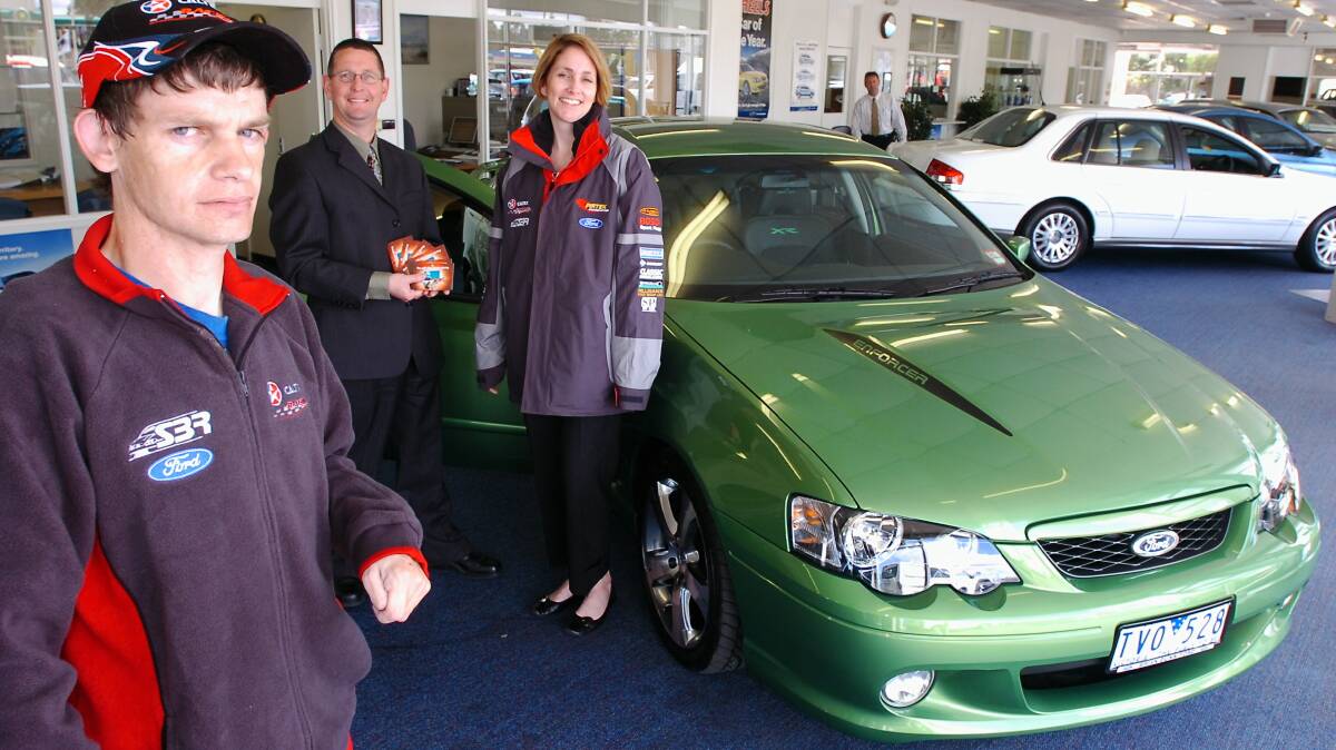from left- Michael O'Connor with his new Ford XR8. In the background is Greg Dunn ( Assistant General Manager @ Brian Dunn) with Bree Taylor (from CALTEX ).
pic by Andrew Perryman on Wed 26th Oct 2005.