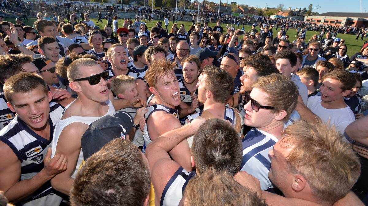 CELEBRATION: Storm fans mob their premiership heroes after Saturday's historic grand final win. Picture: BRENDAN McCARTHY