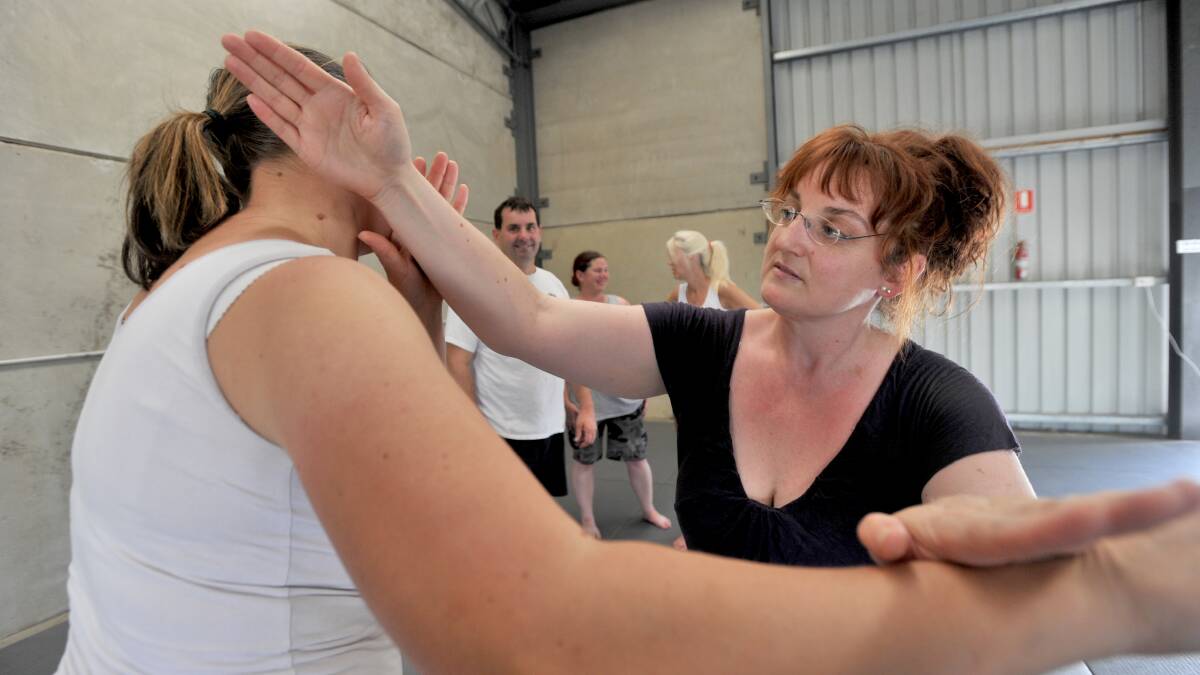 GIRL POWER: Gabby Eccles receives tips off instructor Kat Wilhelm. Picture: JODIE DONNELLAN
