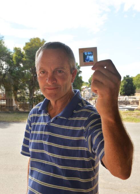 LOST AND FOUND: Gerard Scanlon with one of the slides he found near Bendigo Cemetery. Picture: LIZ FLEMING