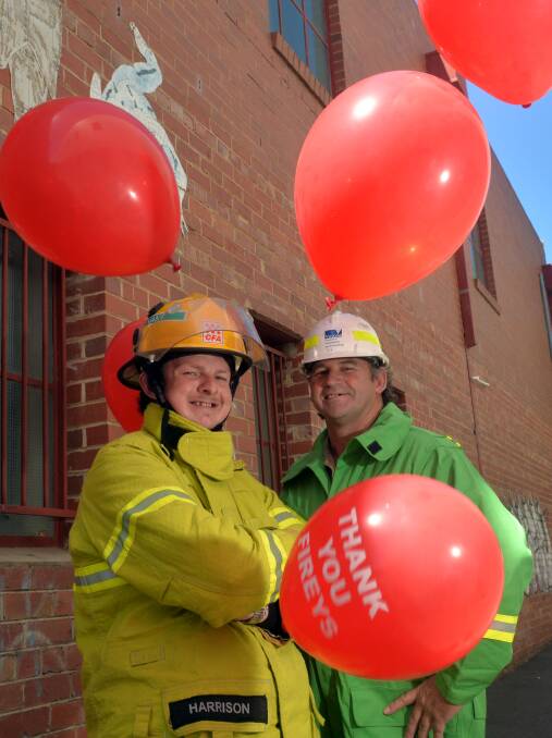 THANKS: Samual Harrison and Tony Scott with red balloons. Picture: BRENDAN McCARTHY