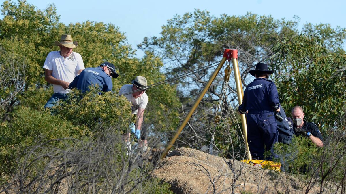 HOMICIDE SQUAD: Ron Iddles, left, at the base of Mount Korong near Inglewood. Wayne Amey's body was found at the site. 