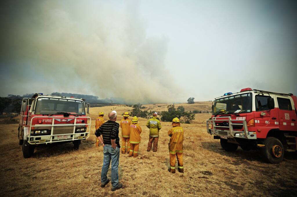 BLAZE: Peter and Matt Brown with CFA crews watching the fire front approach. Picture: STEPHEN BROWN