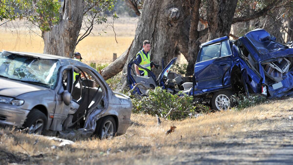 DOUBLE FATALITY: Police inspect a car which two men died in. Picture: BLAIR THOMSON
