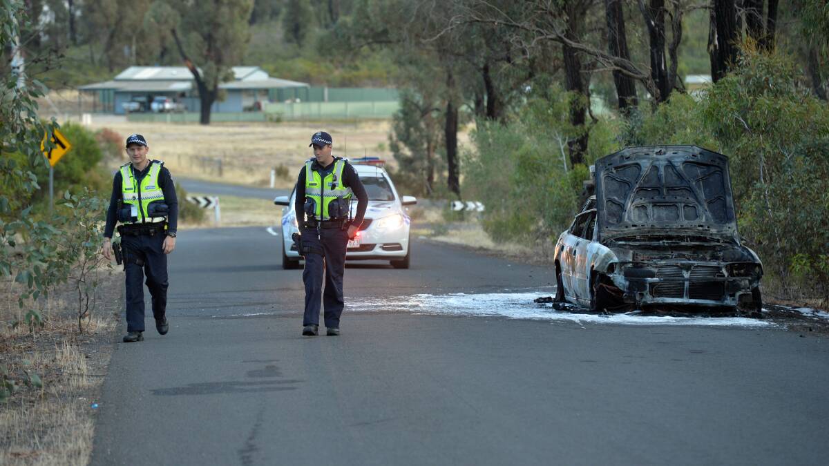 BURNT: Police near a burnt out Subaru in Long Gully. Picture: BLAIR THOMSON