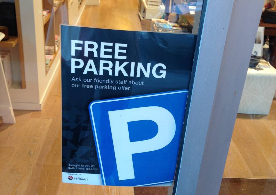 INITIATIVE: Traders displaying this sign in their front window are offering shoppers a free hour of parking in the multi-storey on Edward Street. Picture: ANDI YU