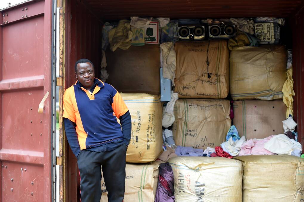 Selemani Ndikumana has had support from the community with clothing donations and from his family and his fellow Burundian friends to pack the items into a shipping container on the nature strip in front of his Kennington home.