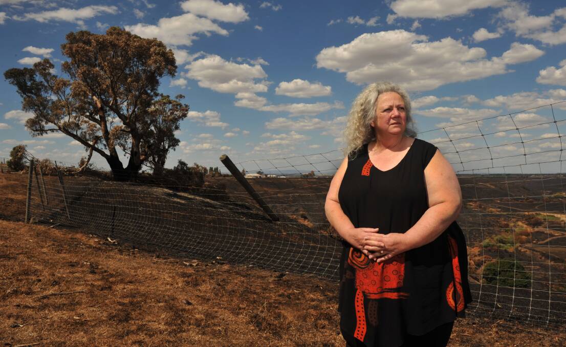 DAMAGE: Mary Horell on her burnt property, Hillcrest Deer Farm, at Gisborne. Picture: BRENDAN McCARTHY