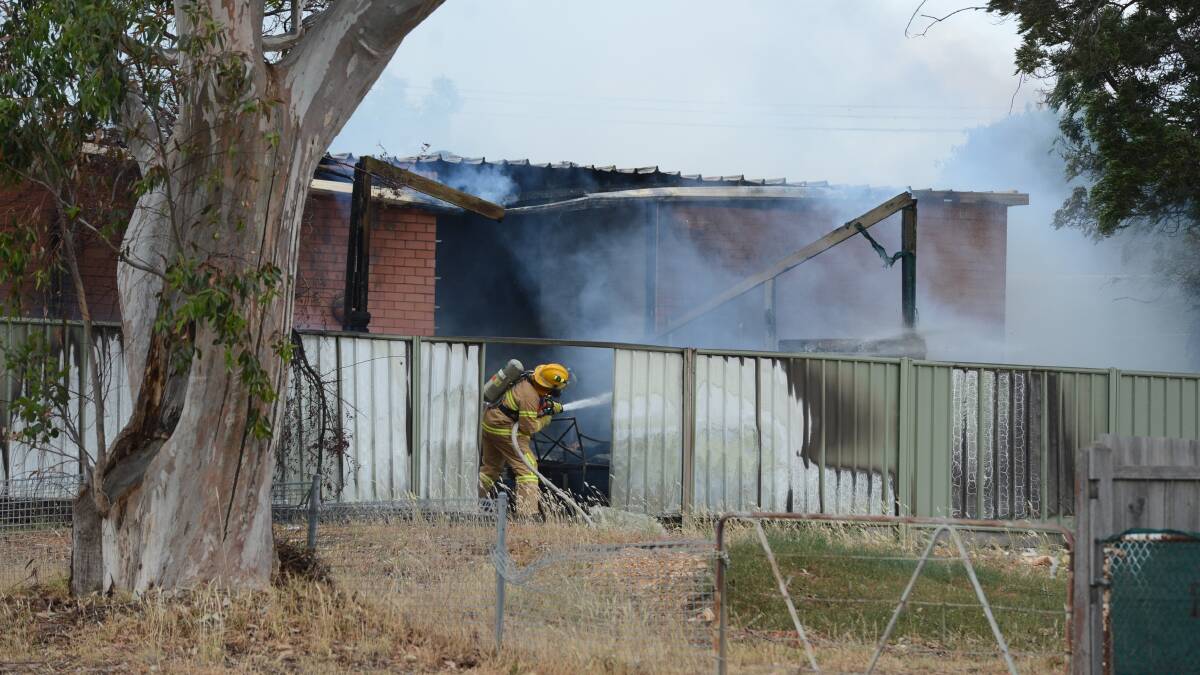 Firefighters battle a house fire at Flora Hill. Picture: JIM ALDERSEY