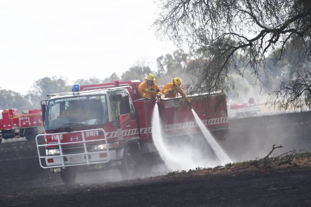 Fire crews blacking out one of the December 2019 fires caused by Scott Hagley, 37, Justin Hagley, 38 and Andrew Valli, 32. Picture: DARREN HOWE