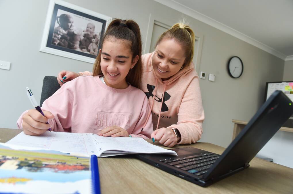 Kylie Challis helping daughter Kiarrah Portelli with her year nine school work. Picture: DARREN HOWE