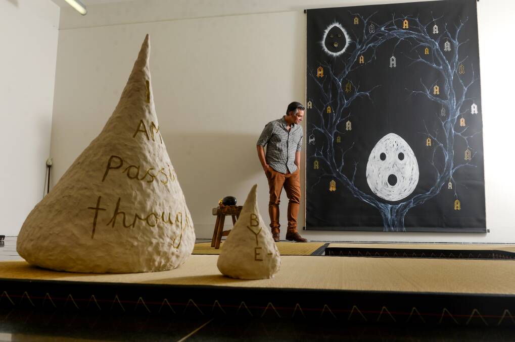 EXPLORE: La Trobe Art Institute curator Travis Curtin with artworks by Nell in the exhibition One Foot on the Ground, One Foot in the Water. Nells work is the courtesy of the artist and Station Gallery. Picture: DARREN HOWE