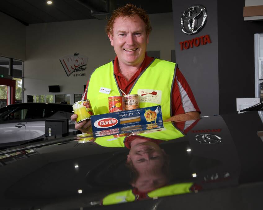 HELPING HAND: Bendigo Toyota's Dave Seiler has gotten into the donation spirit. The business has been collecting items for about five years. Picture: NONI HYETT