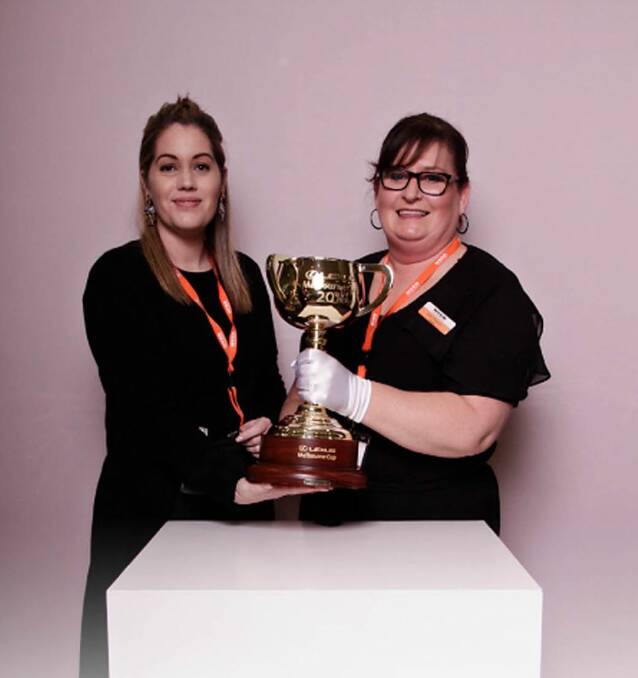 Bendigo Myer workers Angie Davey and Sally Thomson with the Melbourne Cup. Picture: SUPPLIED