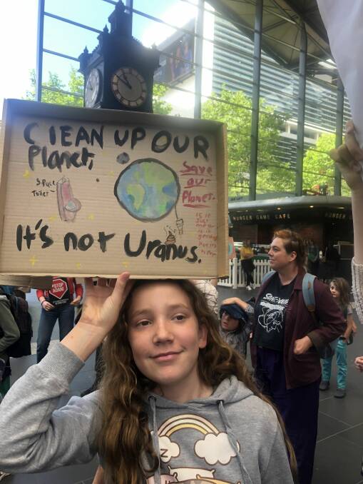 Bendigo student Abby Brownbill holds her sign in Melbourne during the November National Strike. Photo: SUPPLIED