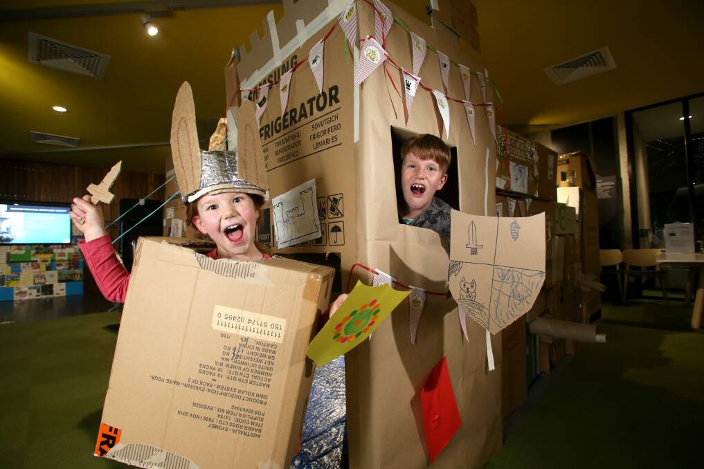 EXCITED: Declan and Katherine Chant enjoy the cardboard castle at the Bendigo Library. Picture: GLENN DANIELS