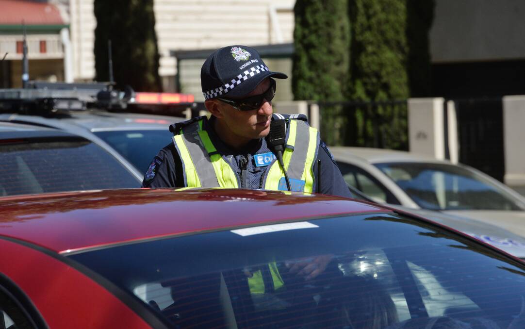 A police officer conducting a breath test on Weeroona Ave. Picture: DARREN HOWE
