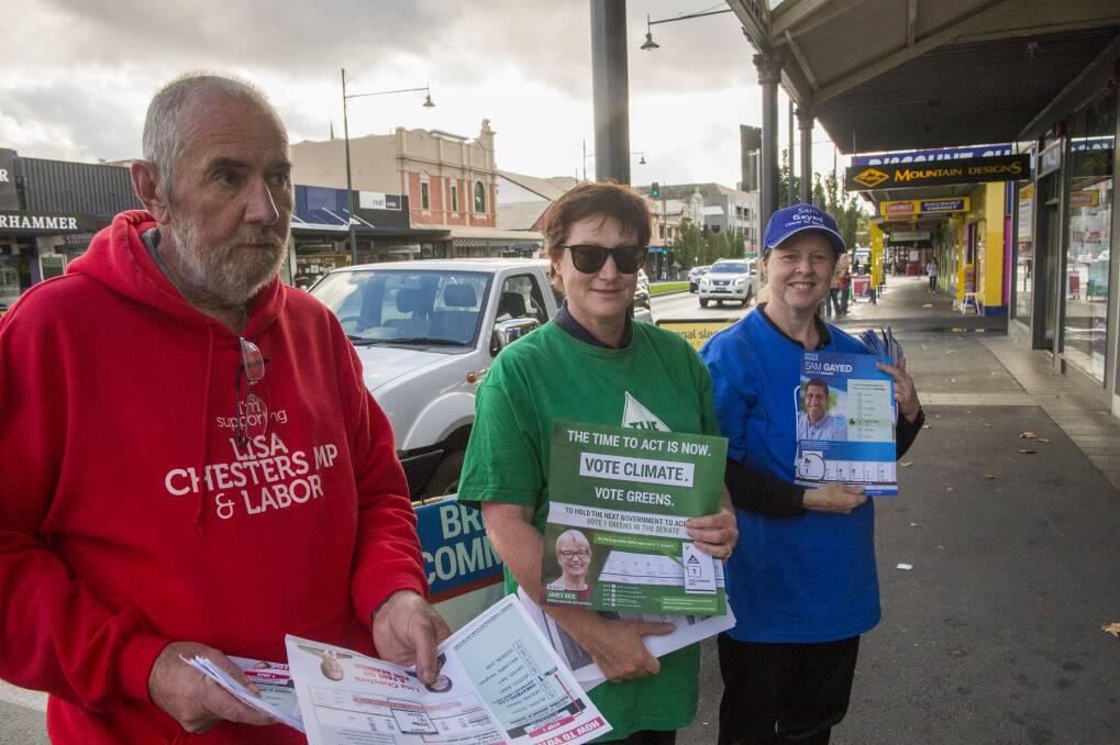 READY: Volunteers hand out vote cards at the pre-polling voting centre in Mitchell Street, Bendigo. Picture: DARREN HOWE
