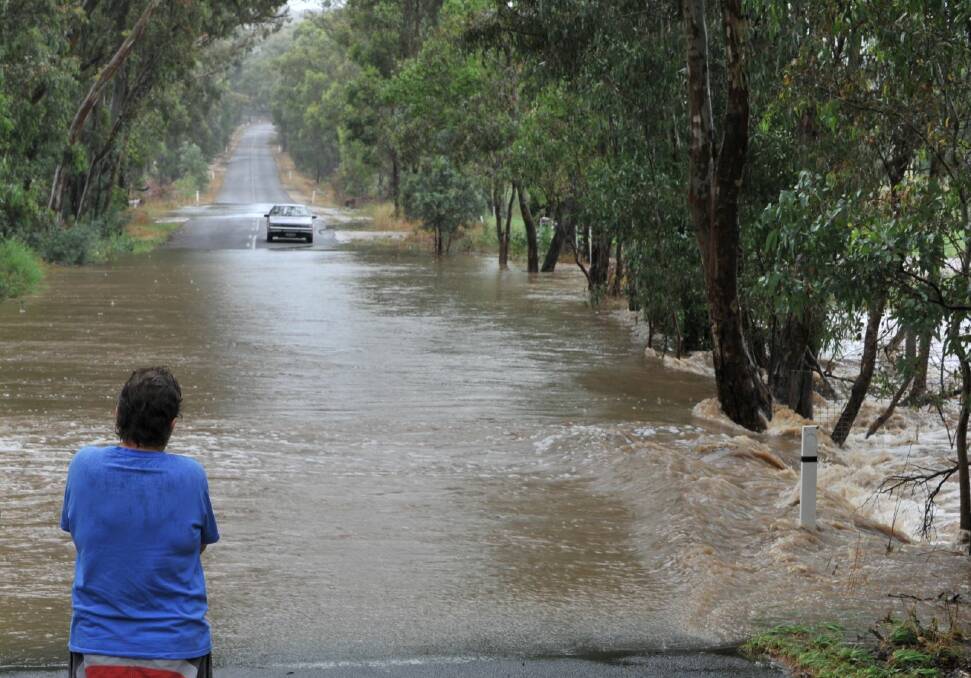 DELUGE: A central Victorian watches the flooding back in 2011. Picture: PETER WEAVING