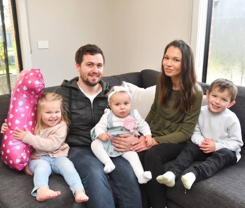 Kara Beer and Michael Roberts with their children Ella, Mia, and Isaac. Picture: NONI HYETT