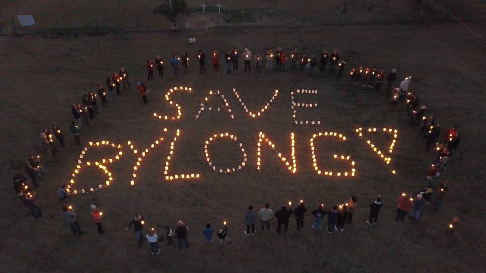 Warning: People at a country music show at Bylong stage a light show in support of the valley in 2019.