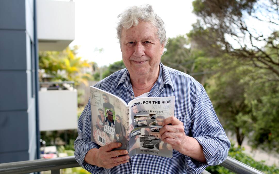 STAR STRUCK: Author David Clement with this book 'Along for the Ride: Fast cars and rock stars' that he penned about his friendship with INXS. Picture: Geoff Jones
