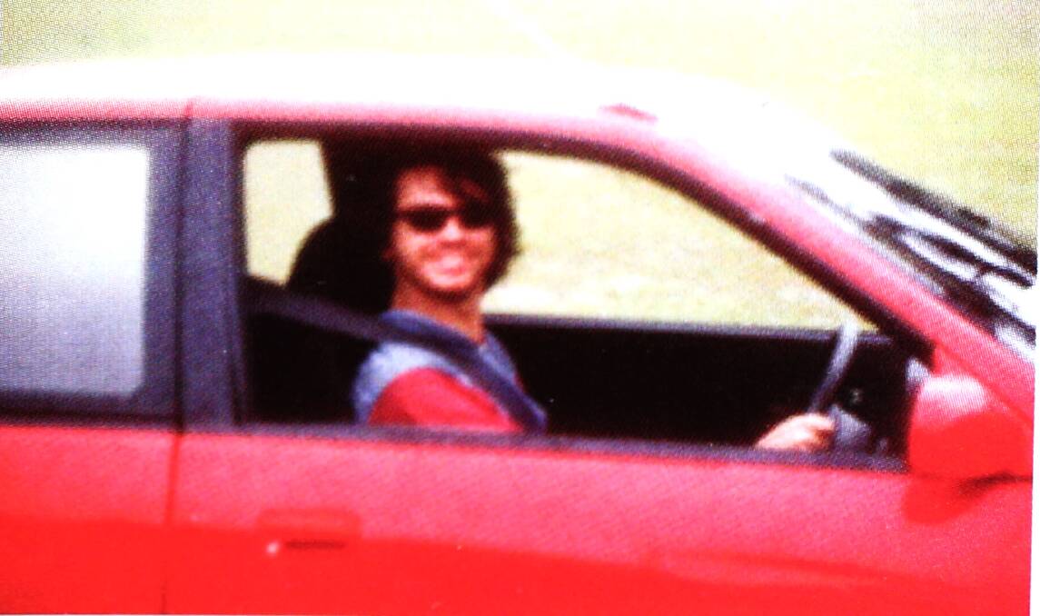 Michael Hutchence behind the wheel during a track day at Amaroo Park Raceway in 1989. Picture: Supplied