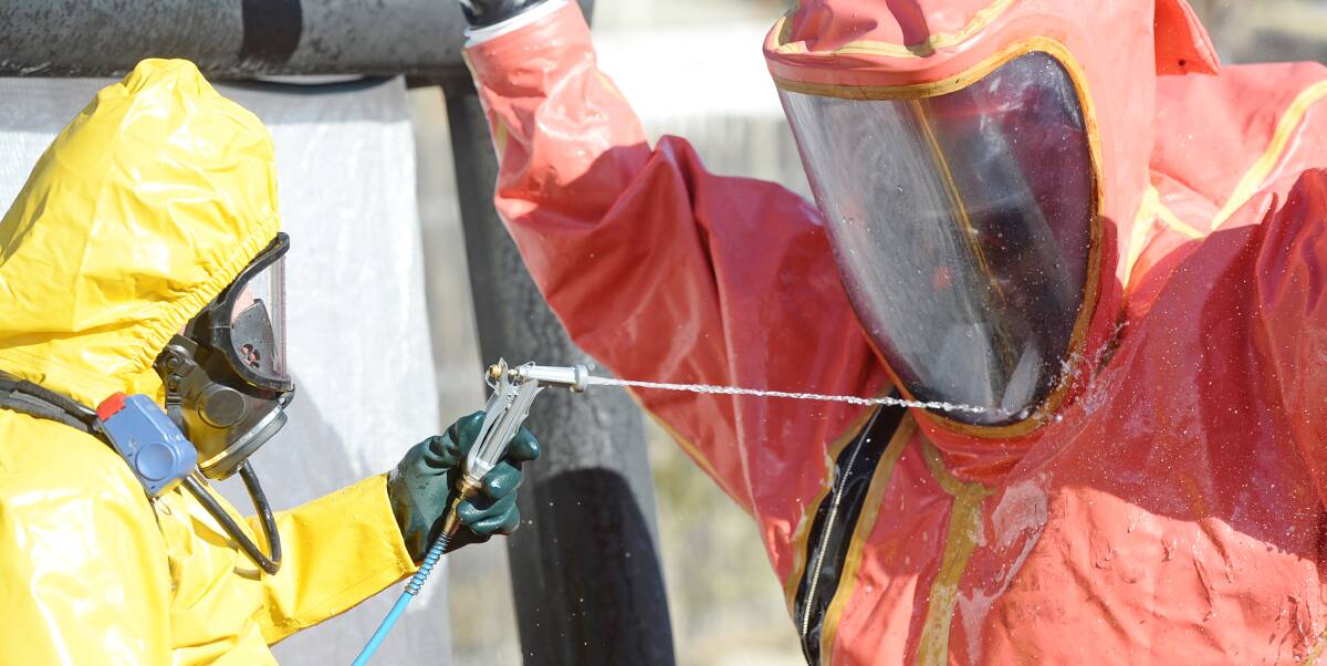 UPSKILL: Regional firefighters take part in a hazmat training session. About 60 volunteer and career firies donned protective equipment to tackle a simulated chemical spill in Golden Square. Pictures: Darren Howe.