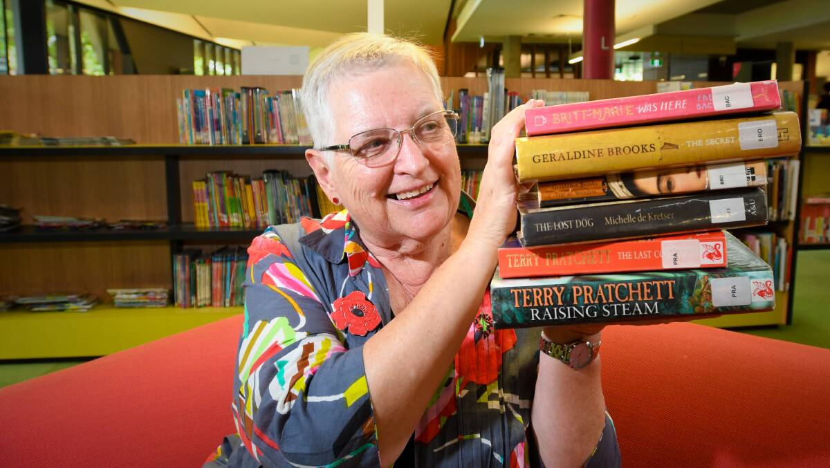 BOOKED UP: Librarian Vivien Newton with a selection of titles in the Autumn Book Binge. Pictures: NONI HYETT
