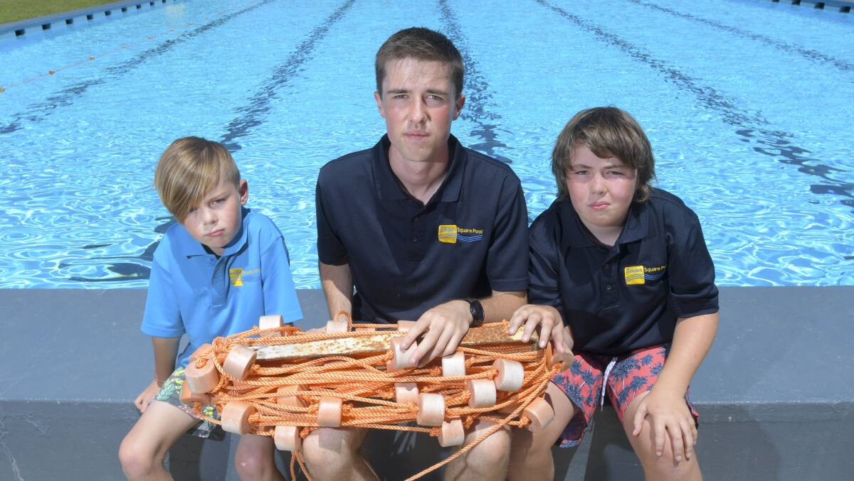 BREAK IN: Jethro Hewitt, Sam Kane and Tex Hewitt hold a lane rope disturbed by trespassers at the Golden Square Pool on Friday night. Picture: NONI HYETT.
