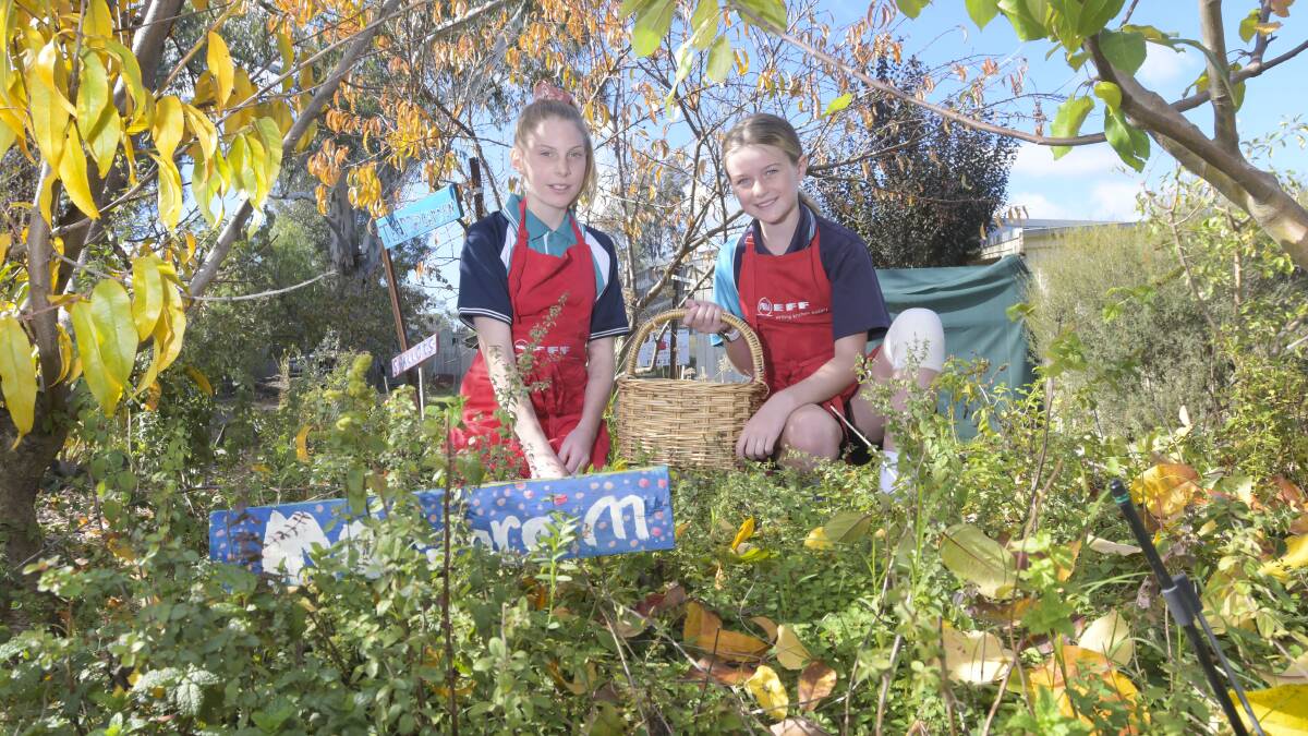 Anthea Carlile and Olivia Henderson in the gardens of Winters Flat Primary School. Picture: NONI HYETT