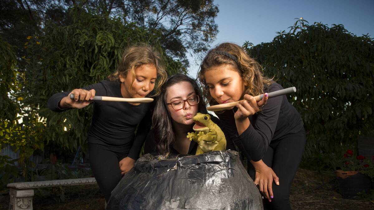 TOIL AND TROUBLE: Performers Lora Soko, Rhiannon Hart and Keziah Soko sample their witches' brew. Picture: DARREN HOWE