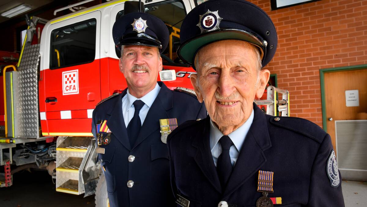 LONGTIME MEMBERS: Bendigo CFA members, and father and son, Max (right) and Ian Ellis have a combined firefighting experience of more than 100 years. Picture: NONI HYETT